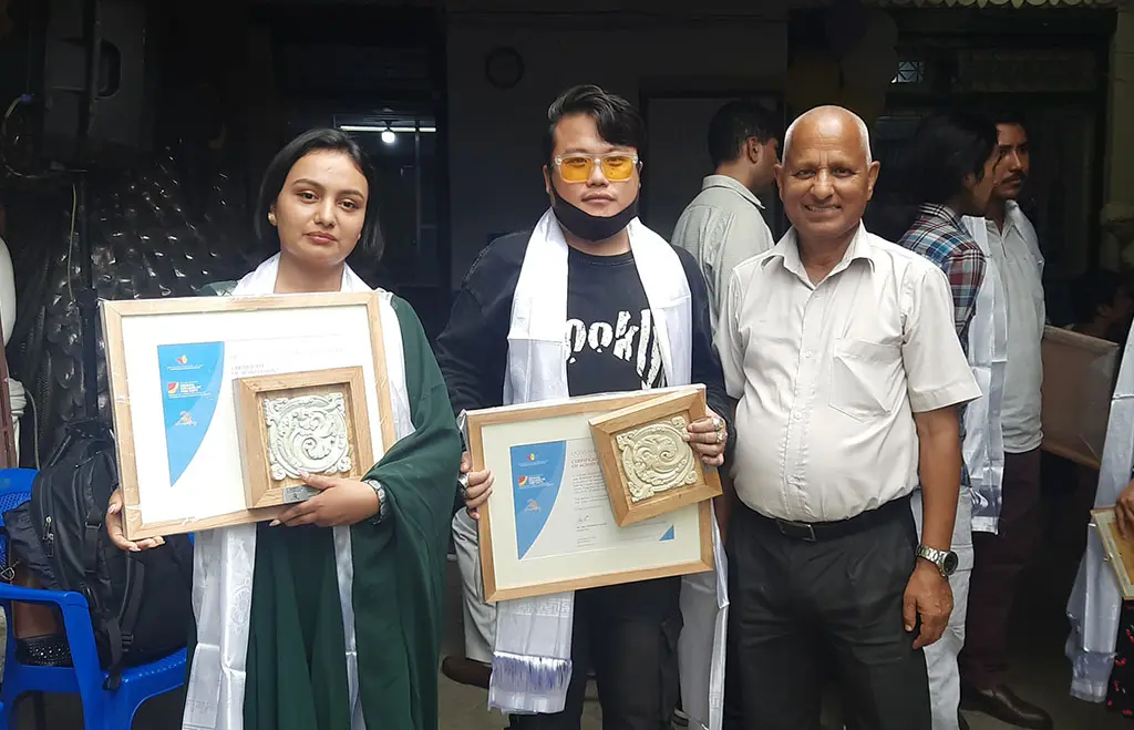 Scholarship partners and guests holding framed certificates
